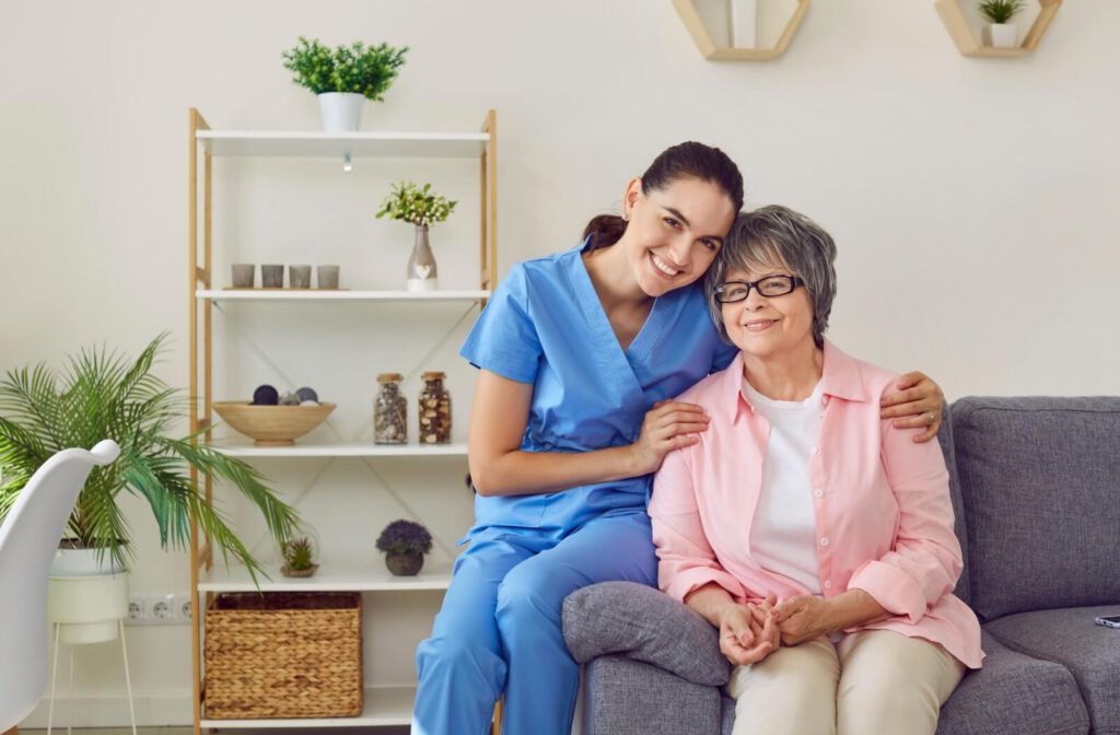 A senior at a memory care community sitting with their friendly nurse